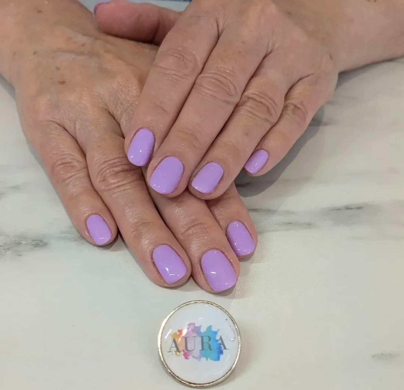 A finished soft lilac manicure by Aura