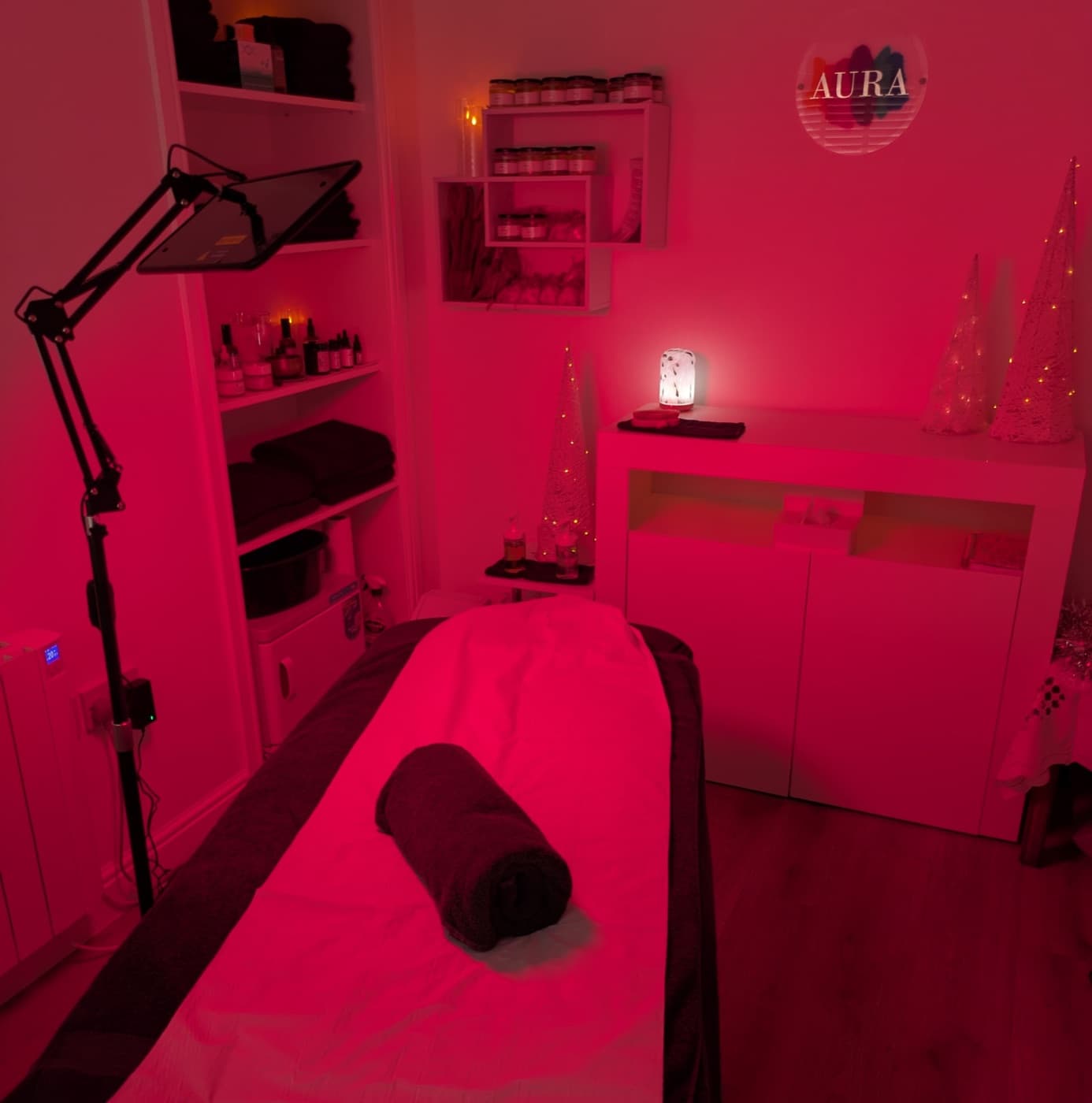 Aura's treatment room under the LED red light therapy lamp