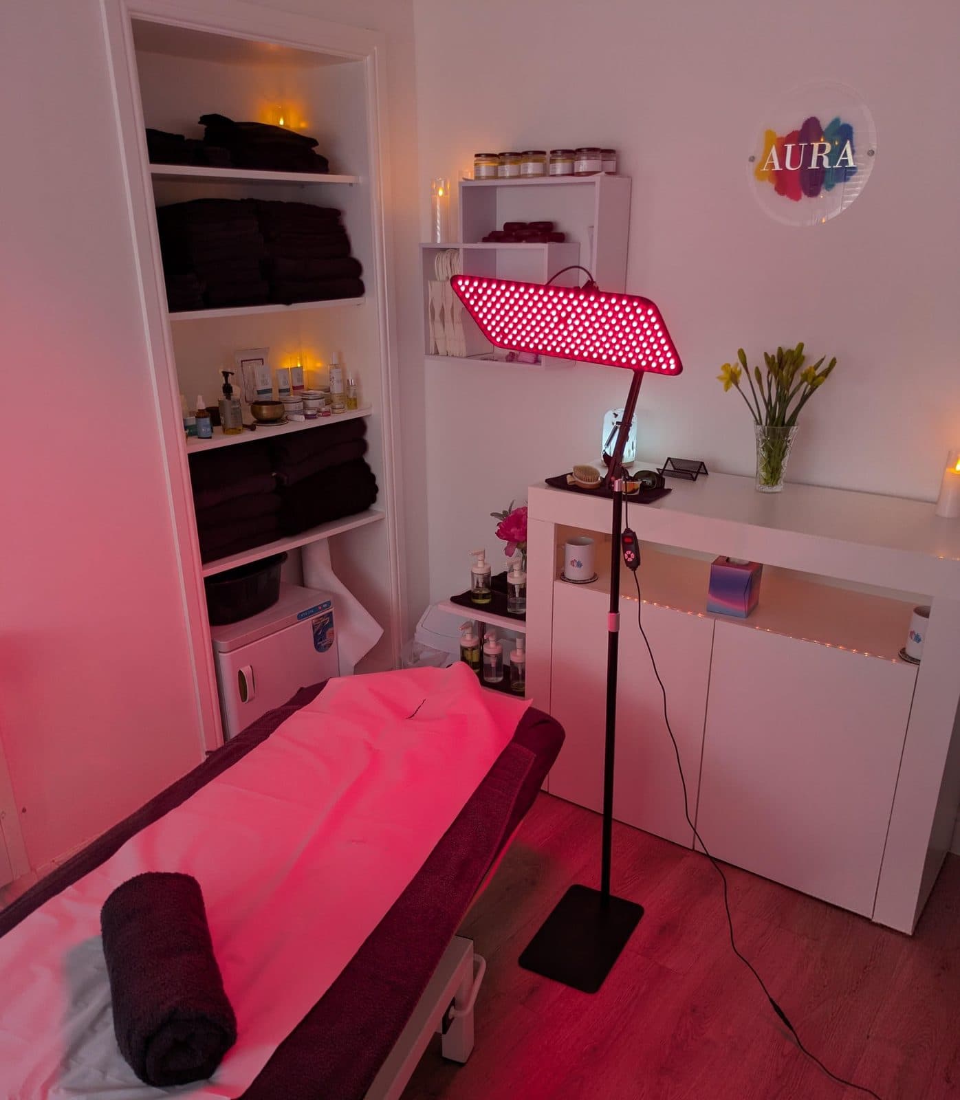 The red light lamp positioned over the couch, with product shelves behind