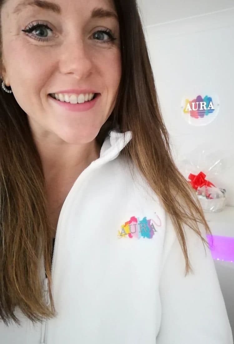 Steph, the therapist and owner of Aura, in her Aura uniform